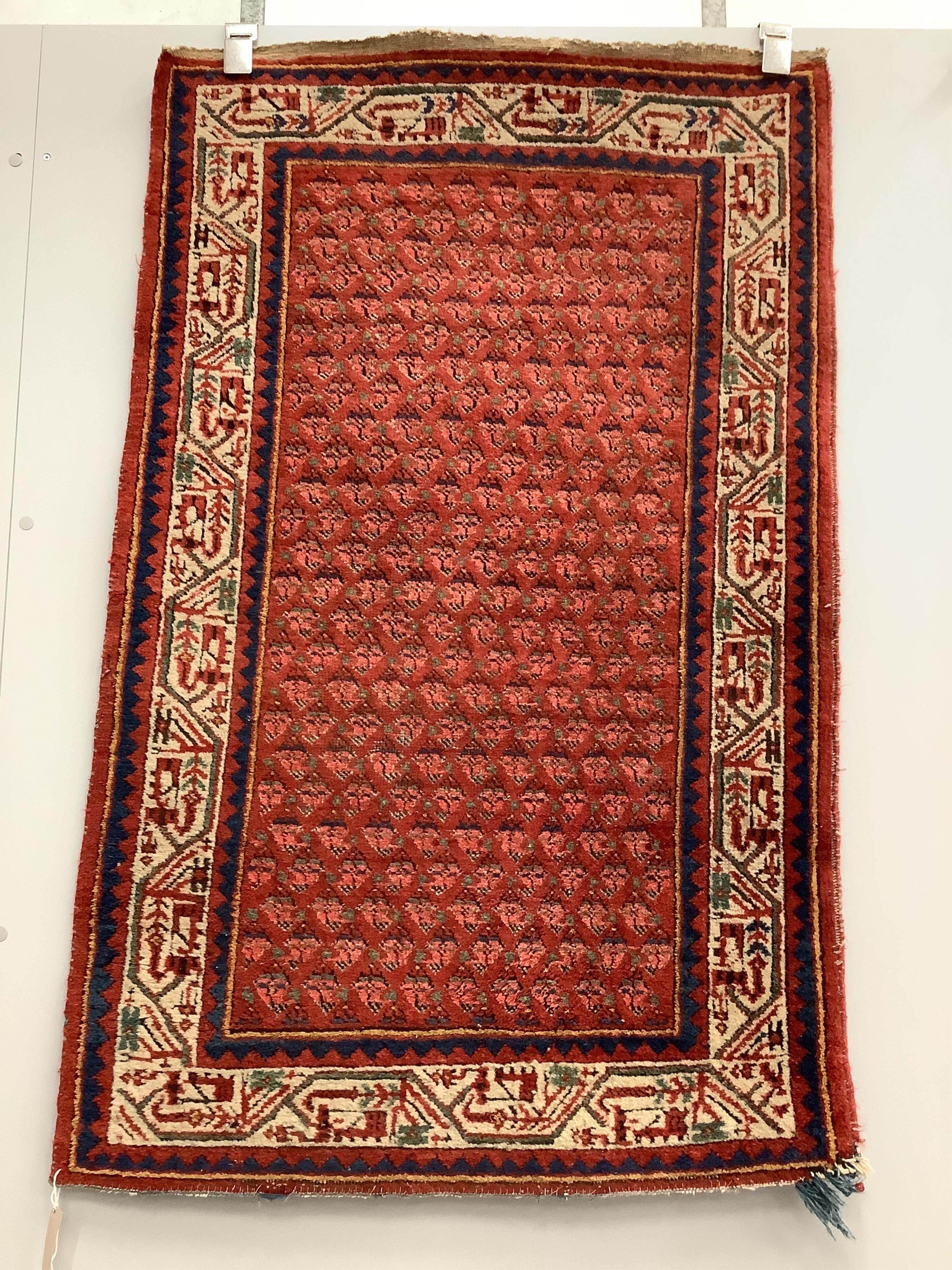 A pair of North West Persian brick red ground rugs, each 124 x 79cm. Condition - fair